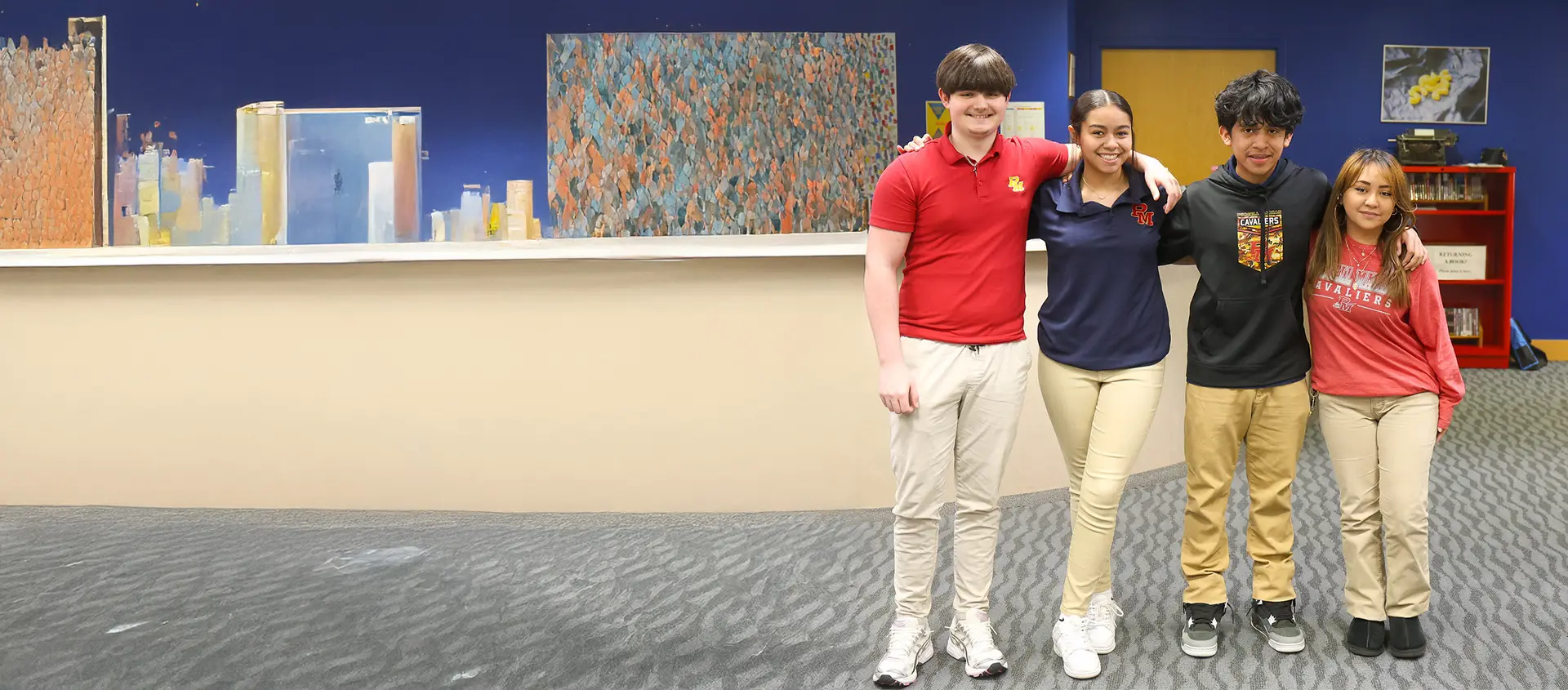 4 students standing in school hallway