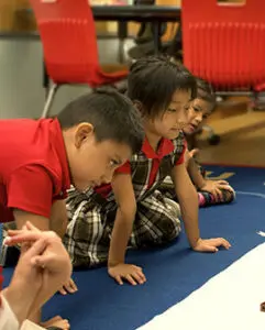 Students sitting in group on the floor