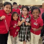 students holding rosaries they made