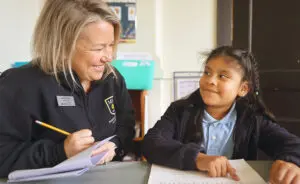 Teacher working with female student
