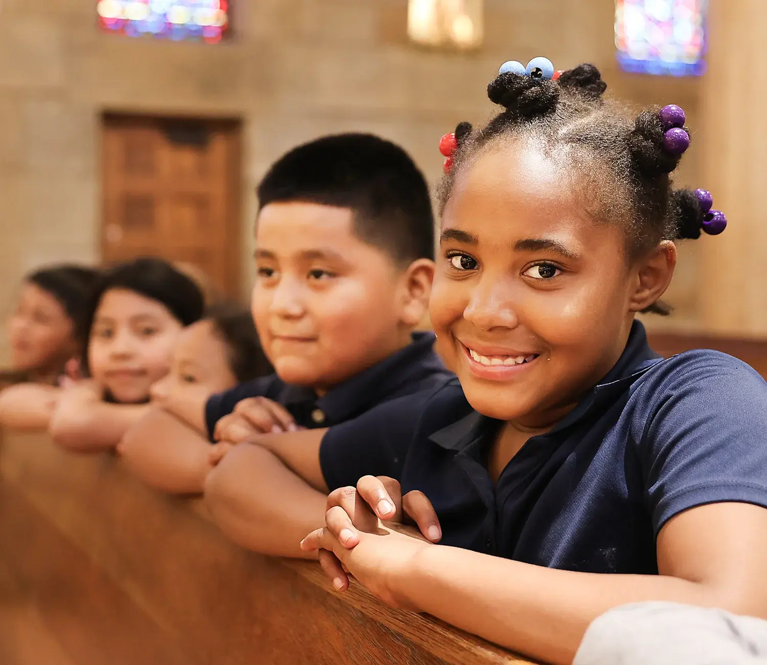Students sitting on church pew