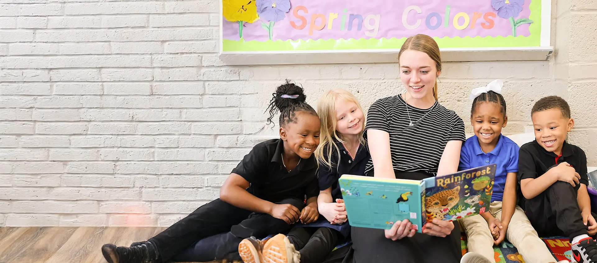 teacher reading book to students