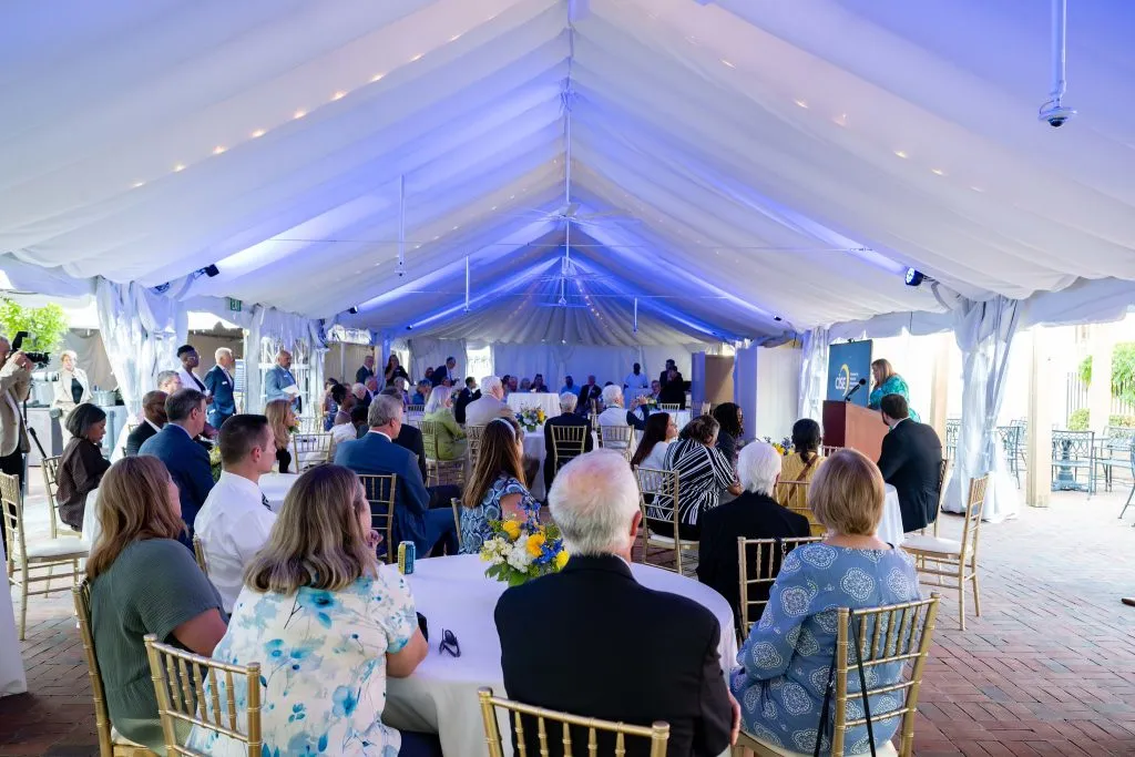 CISE Securing Their Future Campaign - people sitting at tables listening to speakers