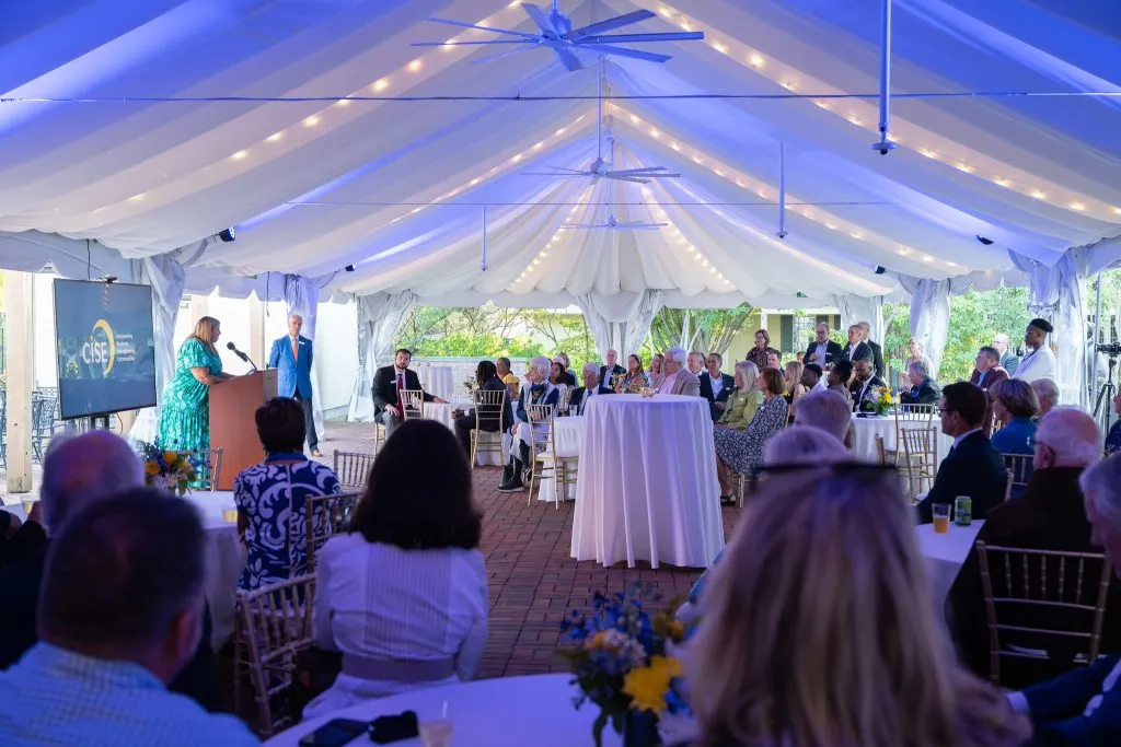 CISE Securing Their Future Campaign - people sitting at tables listening to Katie Puthoff