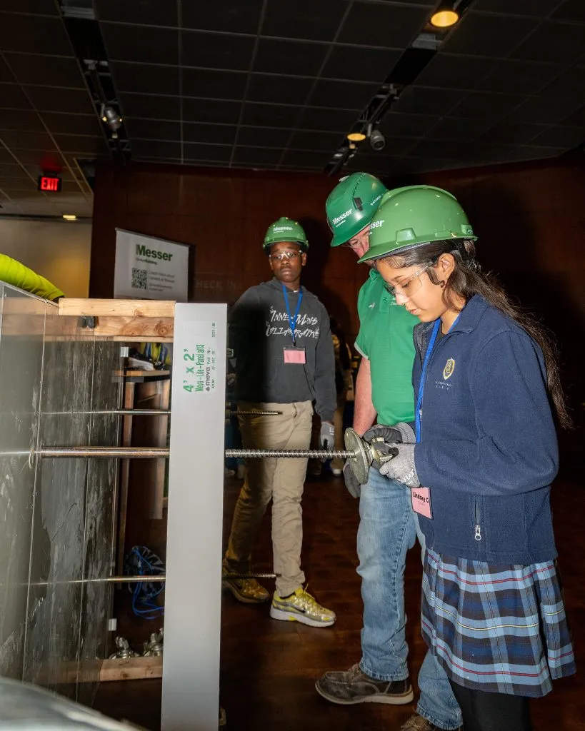 CISE Career Expo - female student using drill