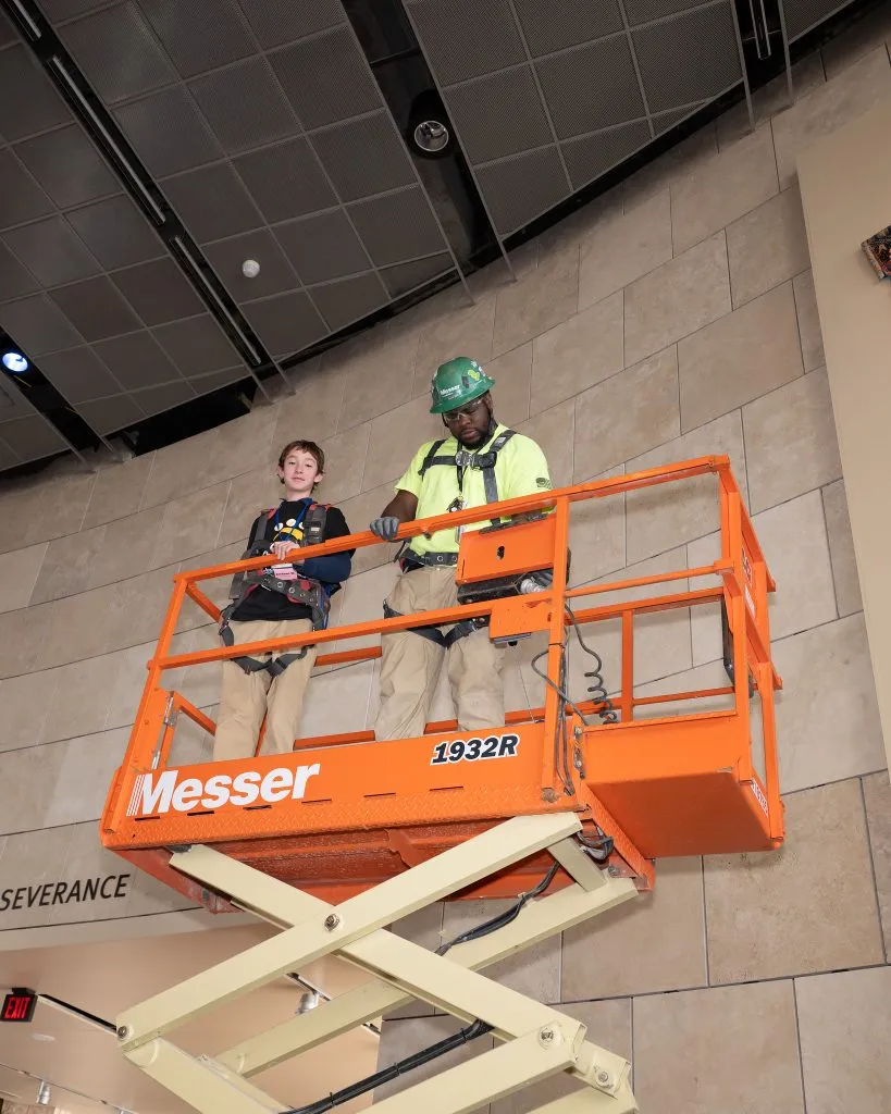CISE Career Expo - male student in scissor lift with construction worker