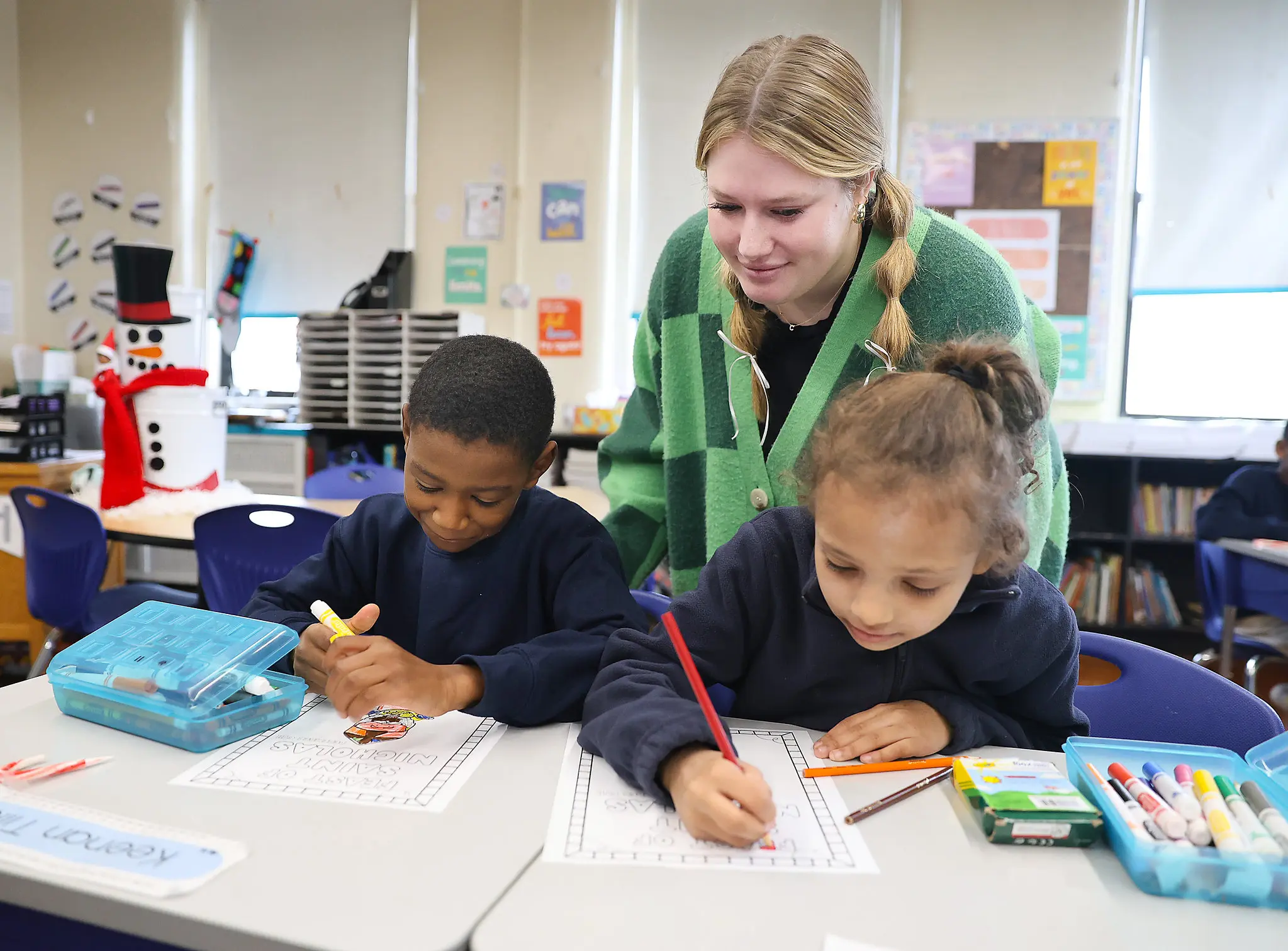 Female teacher working with elementary students